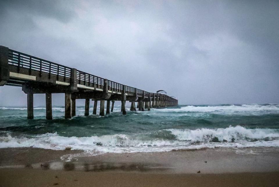 Rain falls near the Lake Worth Pier early Saturday morning June 4, 2022. Heavy rainfall and possible flooding is expected throughout the day.
