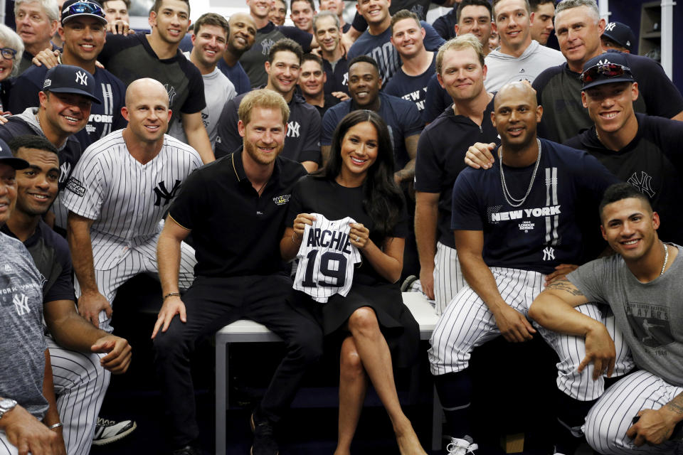 Britain's Prince Harry and Meghan, Duchess of Sussex meet players of the New York Yankees before a match against the Boston Red Sox  in London, Saturday June 29, 2019. (Peter Nicholls/Pool via AP)