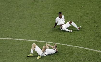 United States&#39; Geoff Cameron, left, and Julian Green sit on the pitch after the loss to Belgium. (AP)