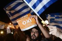 People celebrate in Athens after early referendum results show a large 'No' majority
