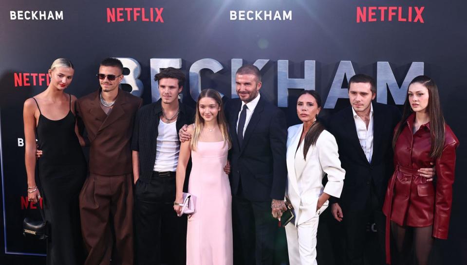 The Beckhams at the Beckham premiere with partners Mia Regan and Nicola Peltz Beckham (AFP via Getty Images)