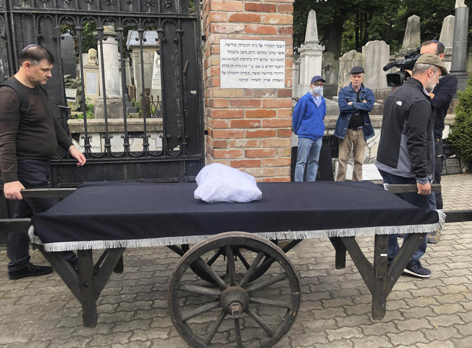 Warsaw's Jewish community hold a funeral for an unidentified Holocaust victim after human remains were recently discovered in an area that belonged to the Warsaw Ghetto during World War II, in Warsaw, Poland, Tuesday Sept. 14, 2021. The remains were buried in Warsaw's Jewish Cemetery, with the country's chief rabbi saying, "We are here as the family for a person we don't know." (AP Photo/Vanessa Gera)