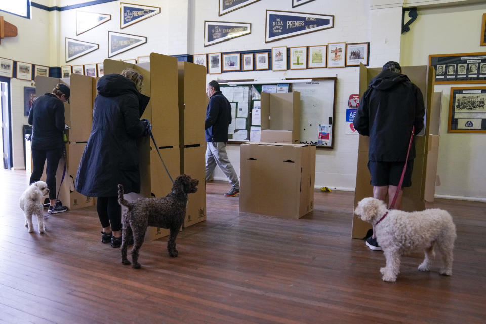 Citizens cast their votes at a polling booth in Sydney, Australia, Saturday, May 21, 2022. Australians go to the polls Saturday following a six-week election campaign that has focused on pandemic-fueled inflation, climate change and fears of a Chinese military outpost being established less than 1,200 miles off Australia's shore.(AP Photo/Mark Baker)