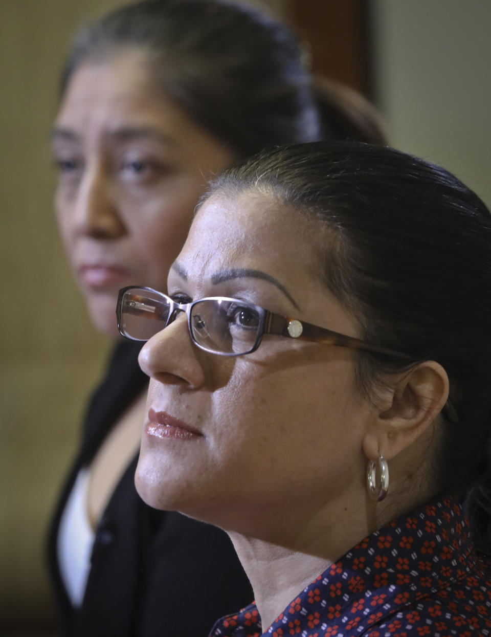 Victorina Morales, left, and Sandra Diaz, right, listen during an interview where they recalled their experience working at President Donald Trump's golf resort in Bedminster, N.J., Friday Dec. 7, 2018, in New York. The women say they used false legal documents to get hired and supervisors knew it. (AP Photo/Bebeto Matthews)