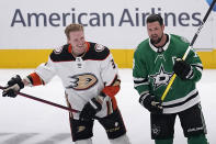 Anaheim Ducks defenseman John Klingberg, left, talks with former teammate Dallas Stars left wing Jamie Benn, right, during warmups before an NHL hockey game, Monday, Feb. 6, 2023, in Dallas. (AP Photo/Tony Gutierrez)