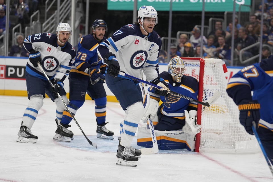 Winnipeg Jets' Adam Lowry (17) looks for the puck during the first period of an NHL hockey game against the St. Louis Blues Tuesday, Nov. 7, 2023, in St. Louis. (AP Photo/Jeff Roberson)