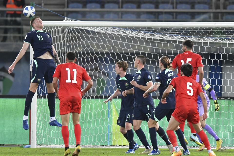 Australia's Harry Souttar heads the ball during a qualifying soccer match against Palestine of the FIFA World Cup 2026 at Jaber Al -Ahmad stadium in Kuwait, Tuesday, Nov. 21, 2023. (AP Photo/Jaber Abdulkhaleg)