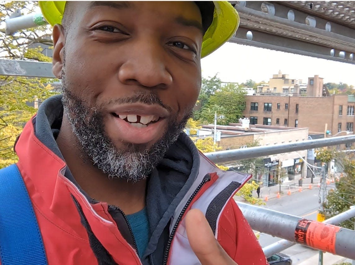 Tochi Osuj on a scaffolding