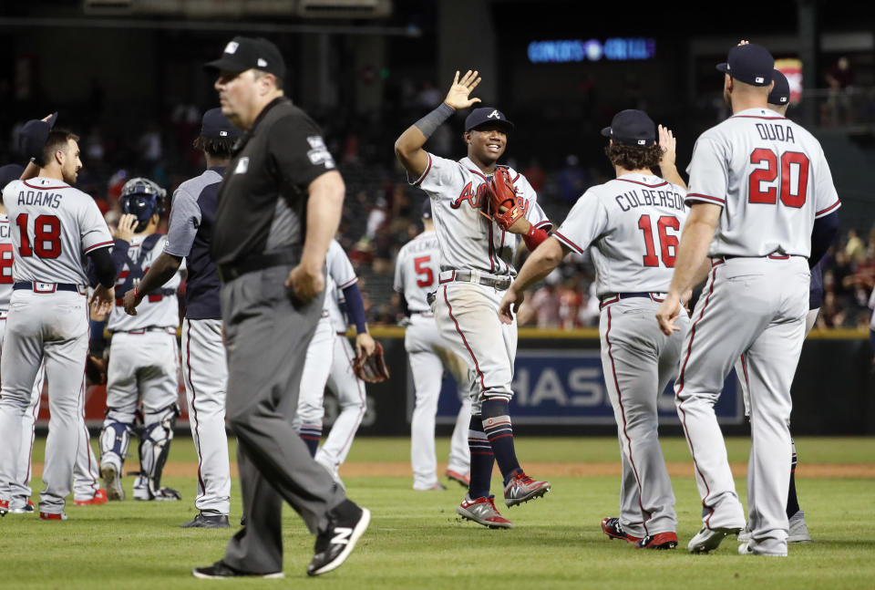 The Atlanta Braves celebrate after a baseball game against the Arizona Diamondbacks, Saturday, Sept. 8, 2018, in Phoenix. The Braves won 5-4 in 10 innings. (AP Photo/Matt York)