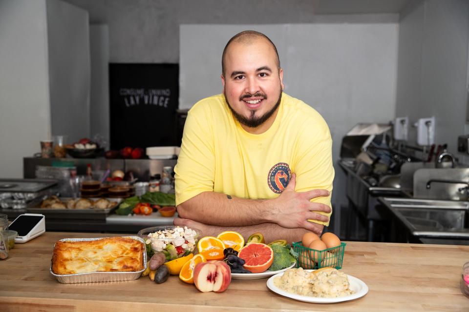 Lay' Vince  owner and chef Jon Merchain displays some of the food items served at the deli and restaurant in Palm Springs.