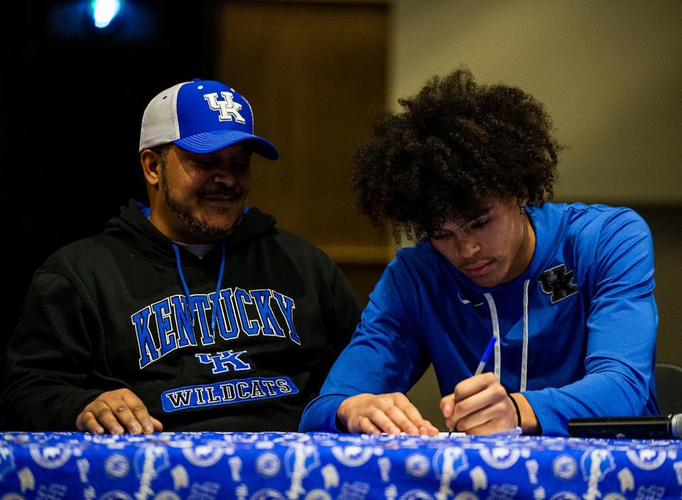 With his father proudly looking on, PRP standout wide receiver Jakob Dixon signs his National Letter of Intent during a signing ceremony at Pleasure Ridge Park High School. Dec. 21, 2021