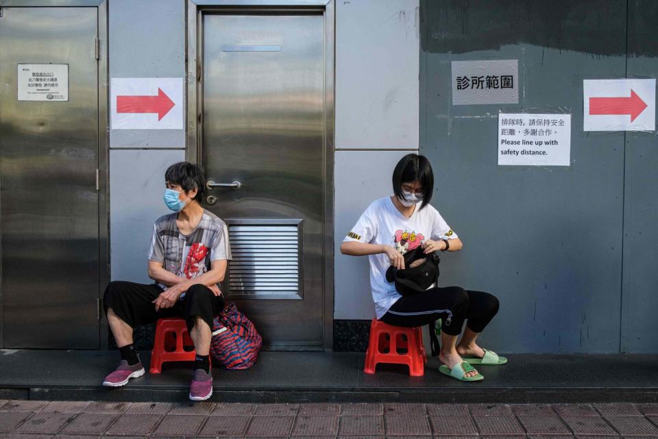 Residents keep their distance as they line up for testing kits (AFP via Getty Images)