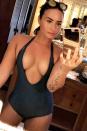 <p>Demi in a one-piece that's basically a bikini.</p>