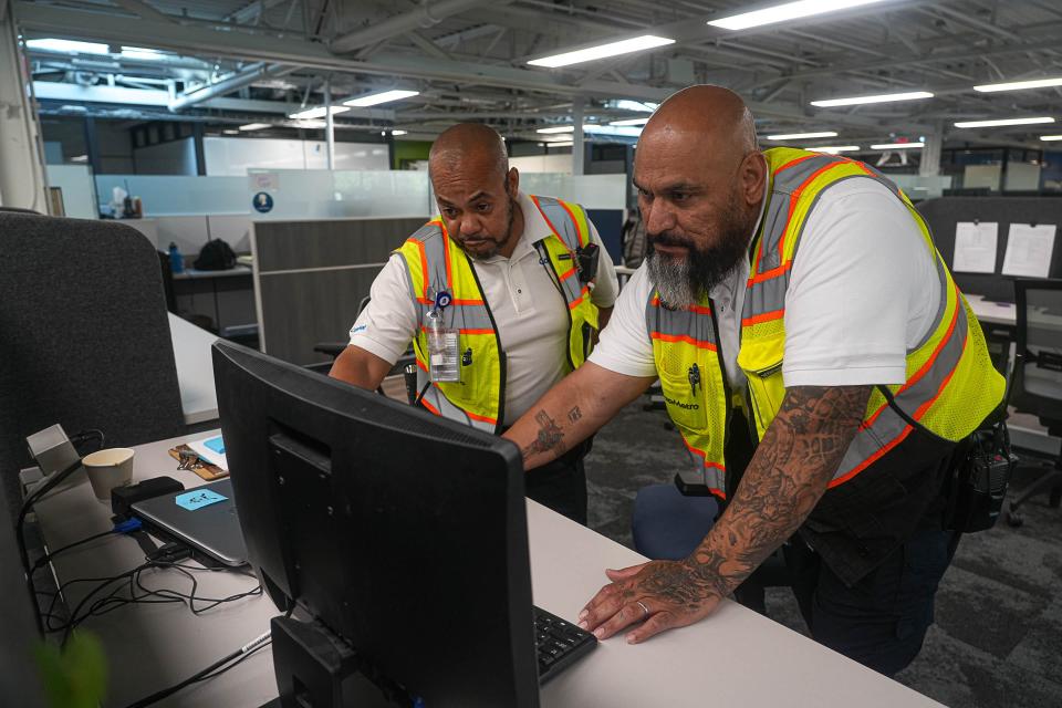 Public safety ambassadors Darrell Hunt, left, and Joel Salinas work in the CapMetro Public Safety Program offices July 28. The ambassadors meet in their office to plan daily tasks and to assign patrol sectors.