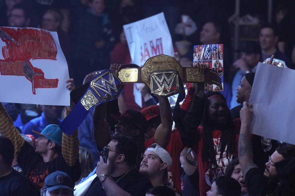 Wrestling fans cheer during the WWE Monday Night RAW event, Monday, March 6, 2023, in Boston. WWE’s WrestleMania arrives this weekend, Saturday, April 1, to a massive audience and vastly larger advertising revenue as it seeks to establish itself as a serious contender for major advertising bucks. (AP Photo/Charles Krupa)