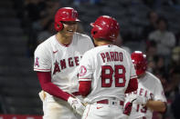 Los Angeles Angels designated hitter Shohei Ohtani, right, laughs at the bat boy after being intentionally walked during the ninth inning of a baseball game against the Seattle Mariners Friday, Sept. 24, 2021, in Anaheim, Calif. (AP Photo/Mark J. Terrill)