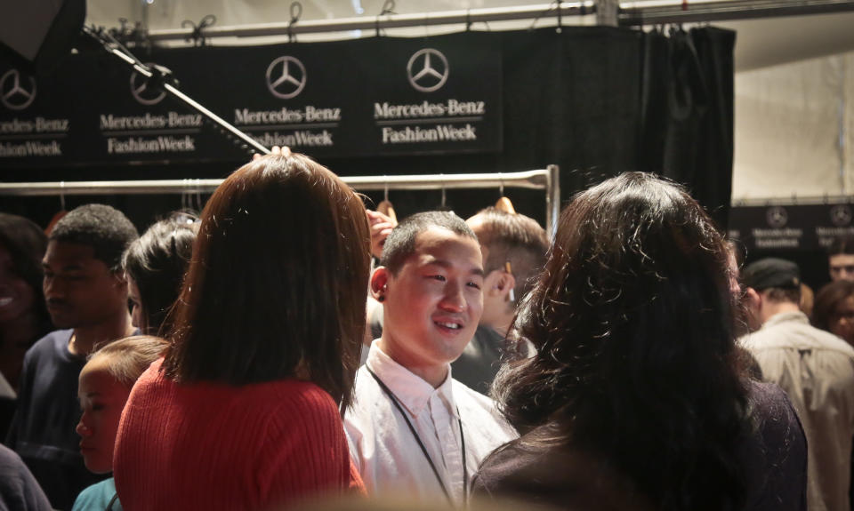 Fashion Richard Chai, center, listens as he meets visitors backstage before showing his Spring Summer 2014 collection on Thursday, Sept. 5, 2013 during Fashion Week in New York. (AP Photo/Bebeto Matthews)