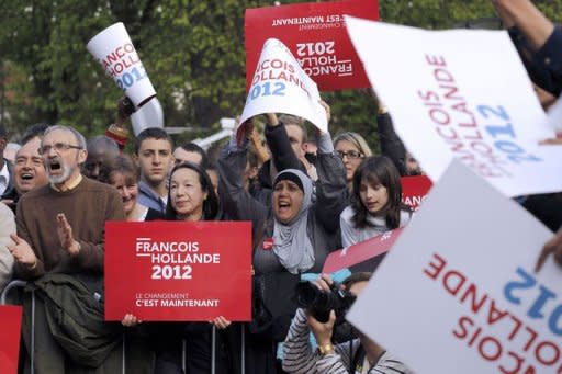 Supporters of Socialist Party candidate for the 2012 French presidential election, Francois Hollande, cheer their candidate during a campaign meeting in Chelles