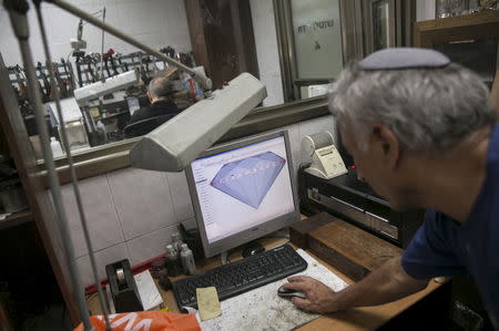 A worker uses software on a computer during the diamond polishing process at a factory in Ramat Gan near Tel Aviv, Israel June 22, 2015. Picture taken June 22, 2015. REUTERS/Baz Ratner