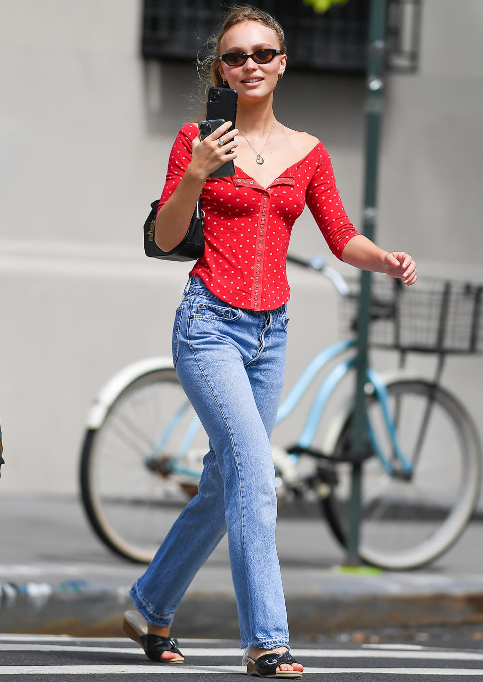 <p>Lily-Rose Depp chats with a friend on her way to grab coffee on Aug. 17 in N.Y.C.</p>