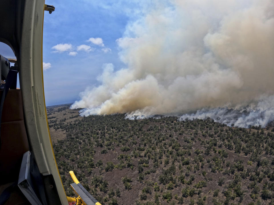 This photo provided by the Hawaii Department of Land and Natural Resources shows a large wildfire in a rural area of Hawaii's Big Island that is not threatening any homes, but high winds and extremely dry conditions are making it difficult for crews to contain the blaze. (Hawaii Department of Land and Natural Resources via AP)