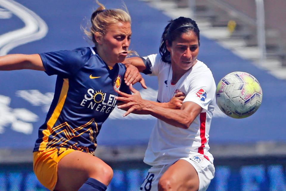 Utah Royals FC defender Madeline Nolf (left) battles with OL Reign midfielder Shirley Cruz during the first half of an NWSL Challenge Cup match at Zions Bank Stadium on July 8, 2020.