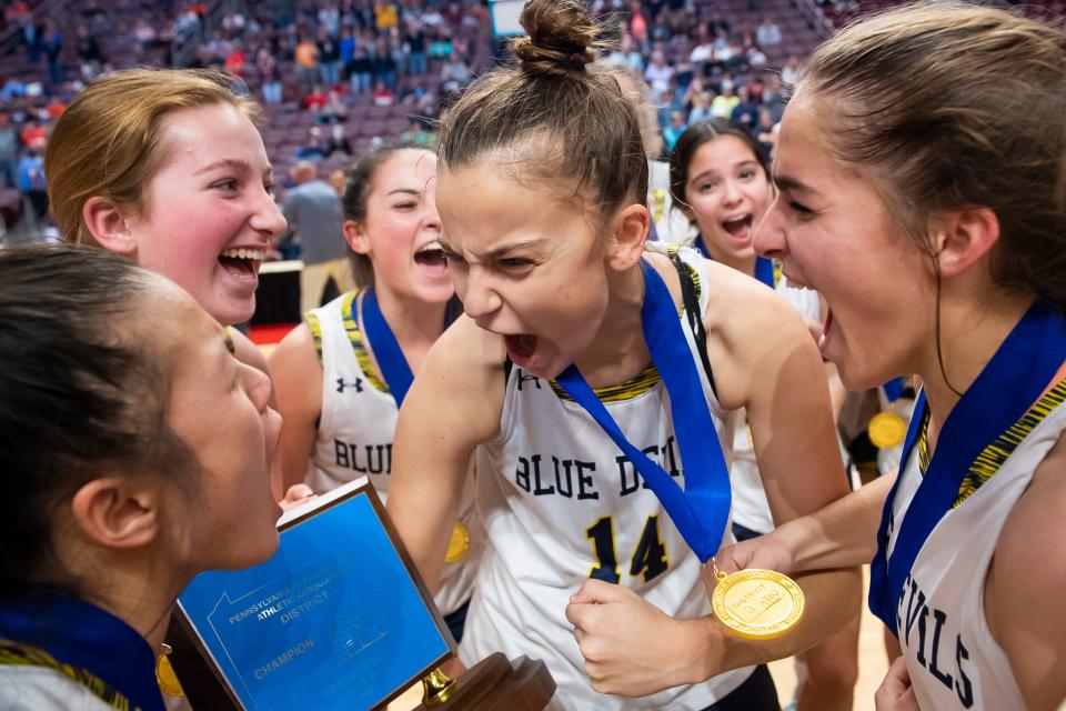 Greencastle-Antrim senior Rylee Henson (14) celebrates with her teammates on the court after winning the District 3 Class 5A girls' basketball championship at the Giant Center on March 2, 2023, in Derry Township. The Blue Devils defeated York Suburban, 44-30.