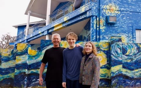 Lubomir Jastrzebski and Nancy Nembhauser pose with their adult son in front of the house in Mount Dora, Florida - Credit:  REUTERS