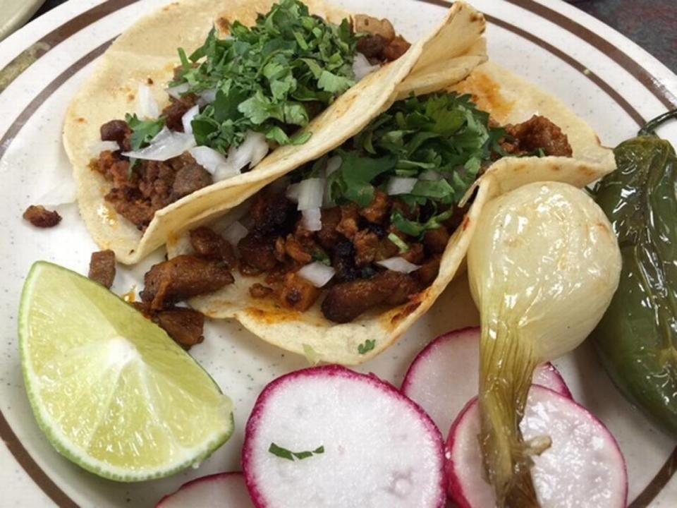 At Tacos El Nevado, the tacos are served very simply: Corn tortillas, meat, onions, a little cilantro, and a whole onion and jalapeno on your plate.