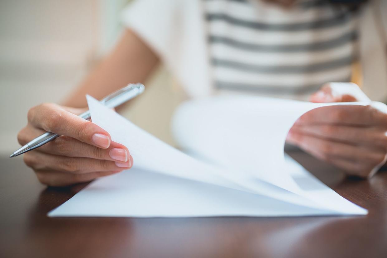 Close-up of female hands, sign paper document in the office