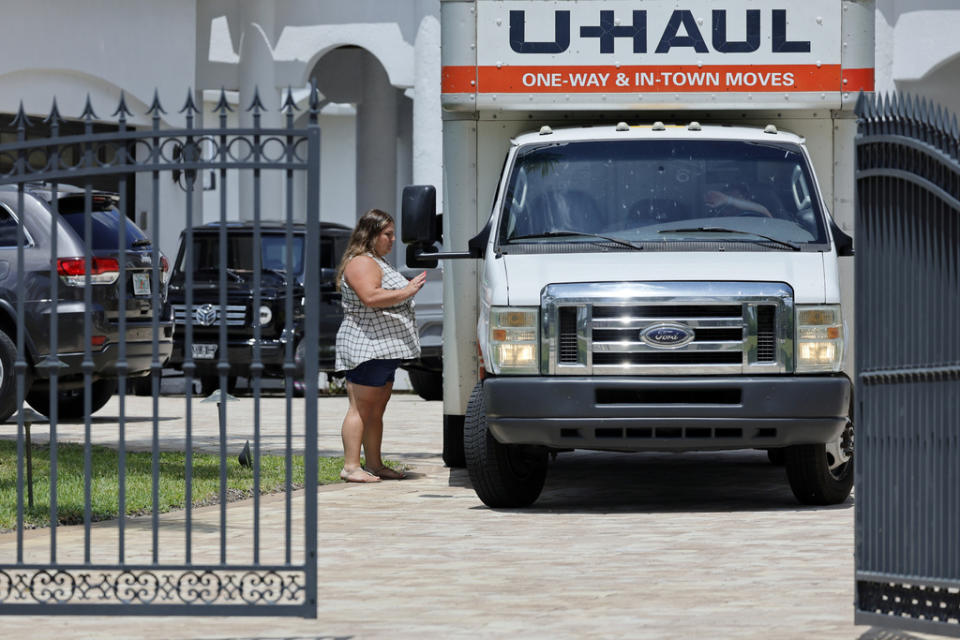 A woman leaves Sean Kingston’s Southwest Ranches, Fla., home Thursday, May 23, 2024. Attorney Dennis Card said she was one of the owners of an $80,000 bed and had flown in from Utah to retrieve it. A SWAT team raided rapper Kingston’s rented mansion on Thursday, and arrested his mother on fraud and theft charges that an attorney says stems partly from the installation of a massive TV at the home. (Amy Beth Bennett/South Florida Sun-Sentinel via AP)