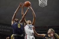 Notre Dame's Maya Dodson (0) and Connecticut's Olivia Nelson-Ododa (20) vie for a rebound in the first half of an NCAA college basketball game, Sunday, Dec. 5, 2021, in Storrs, Conn. (AP Photo/Jessica Hill)