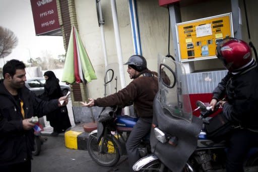 Iranians line up at a petrol station to fuel their motorcycles in central Tehran on February 19, 2012. The United States says it will exempt seven emerging economies including India from tough new sanctions after they cut back on oil from Iran, but the punishment still loomed for China