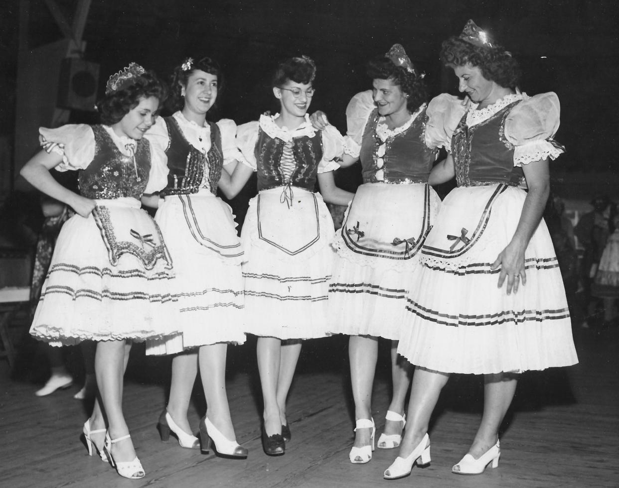 Hungarian American folk dancers Marjorie Bank, Elsie Sivo, Mary Fabian, Louise Bogos and Julia Bogos demonstrate traditional steps in 1945 during a festival at Orchard Park near Boston Heights.