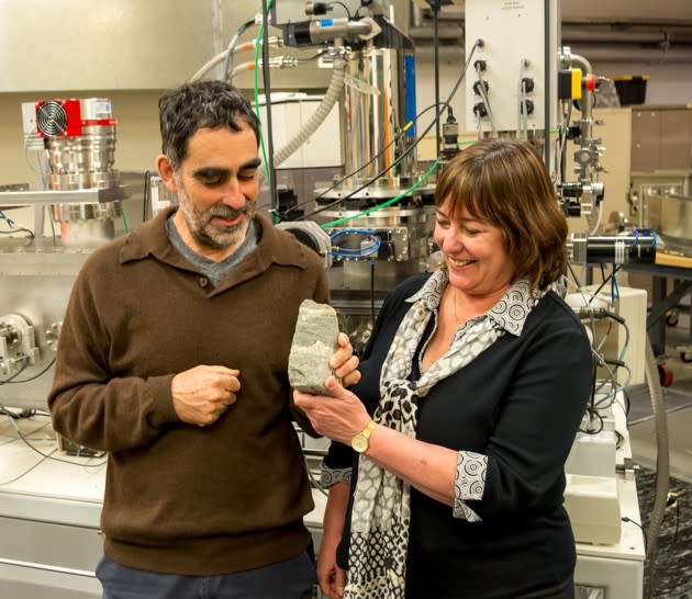 Allen Nutman and Vickie Bennet hold up a specimen of 3.7-billion-year-old stromatolite. Credit: Yuri Amelin