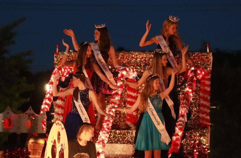 Representatives from the Four Flags Apple Fest in Niles wave to the crowd at Friday's parade.