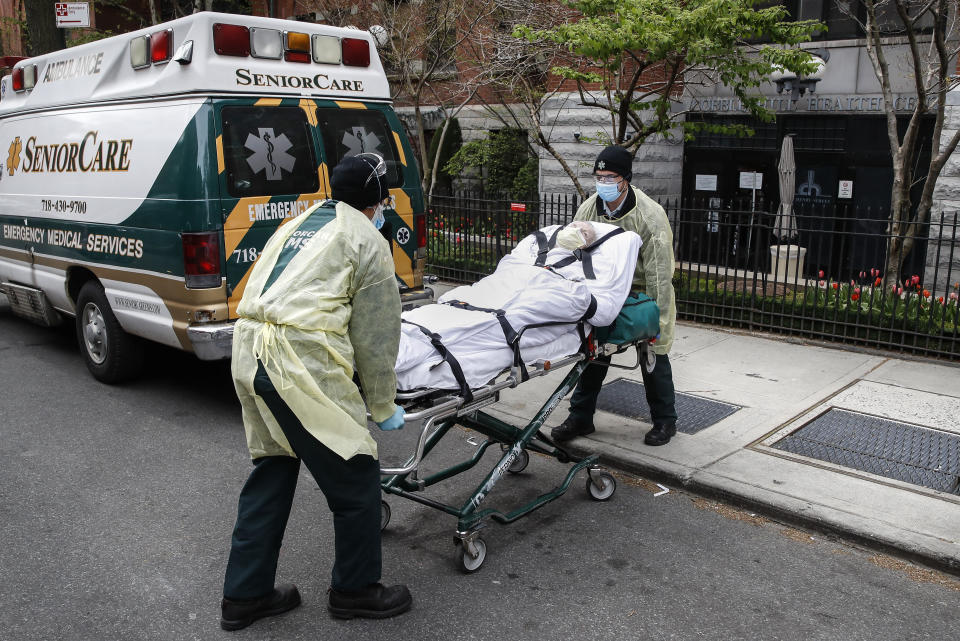 A patient is loaded into the back of an ambulance by emergency medical workers outside Cobble Hill Health Center, Friday, April 17, 2020, in the Brooklyn borough of New York. The despair wrought on nursing homes by the coronavirus was laid bare Friday in a state survey identifying numerous New York facilities where multiple patients have died. Nineteen of the state's nursing homes have each had at least 20 deaths linked to the pandemic. Cobble Hill Health Center was listed as having 55 deaths. (AP Photo/John Minchillo)
