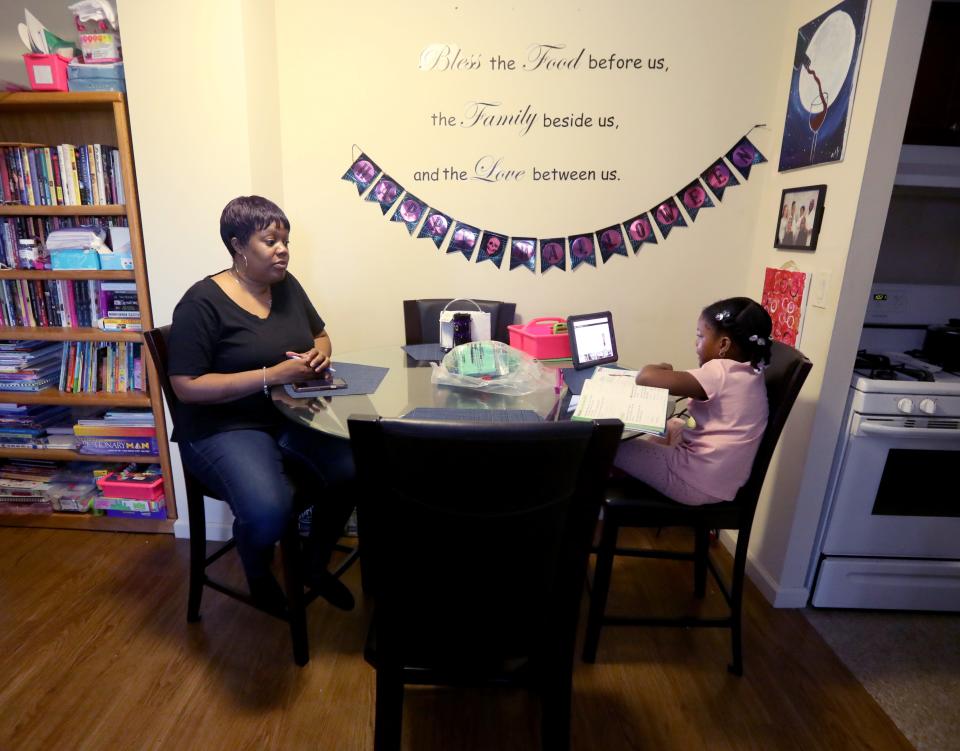 Nicole Johnson watches her daughter Khloe, 6, do school work in their White Plains home Oct. 14, 2020. Johnson, who had worked for the past eight years as a teacher's aide, was forced to give up her job in order to care for her daughter, a second-grader in the White Plains school district who is doing all virtual learning due to the COVID-19 pandemic.