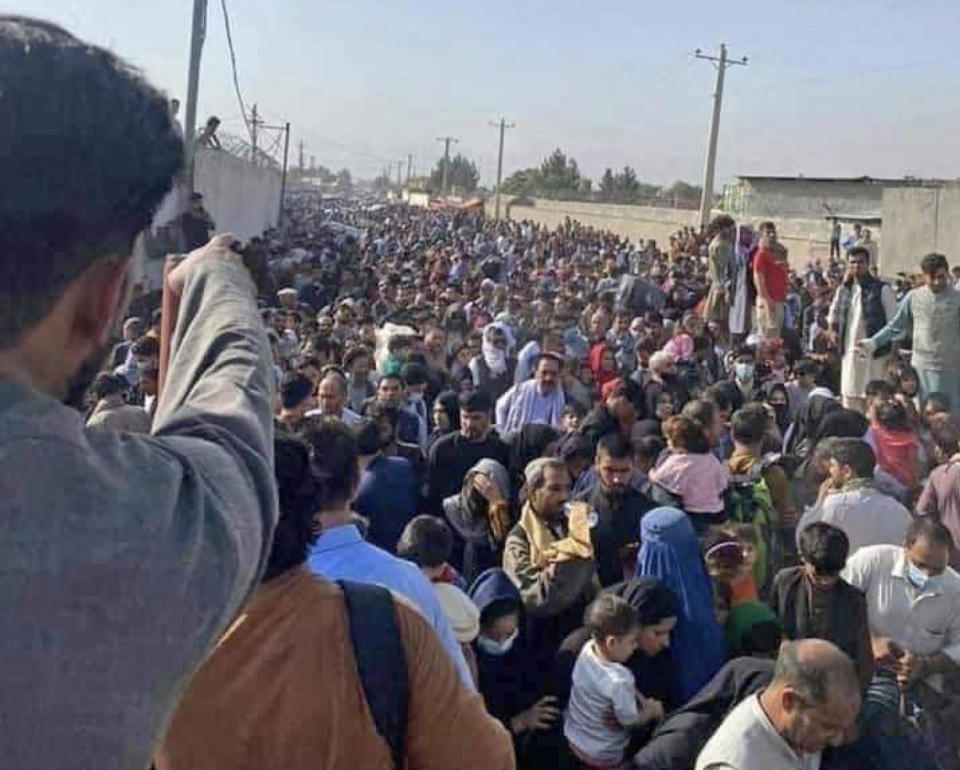 IMAGE: Afghans hoping to be evacuated gather at the airport in Kabul (Najeeb Rahimi)