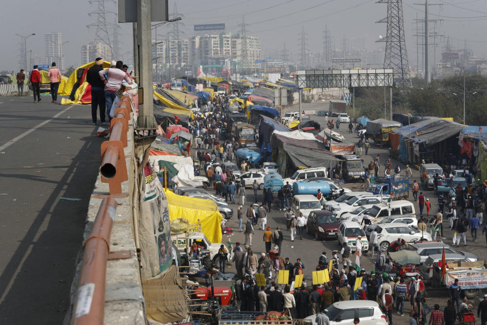 Farmers arrive at Delhi-Uttar Pradesh border to protest against new farm laws, at the Delhi-Uttar Pradesh border, on the outskirts of New Delhi, India, Saturday, Jan. 30, 2021. Indian farmers and their leaders spearheading more than two months of protests against new agriculture laws began a daylong hunger strike Saturday, directing their fury toward Prime Minister Narendra Modi and his government. Farmer leaders said the hunger strike, which coincides with the death anniversary of Indian independence leader Mahatma Gandhi, would reaffirm the peaceful nature of the protests. (AP Photo/Manish Swarup)