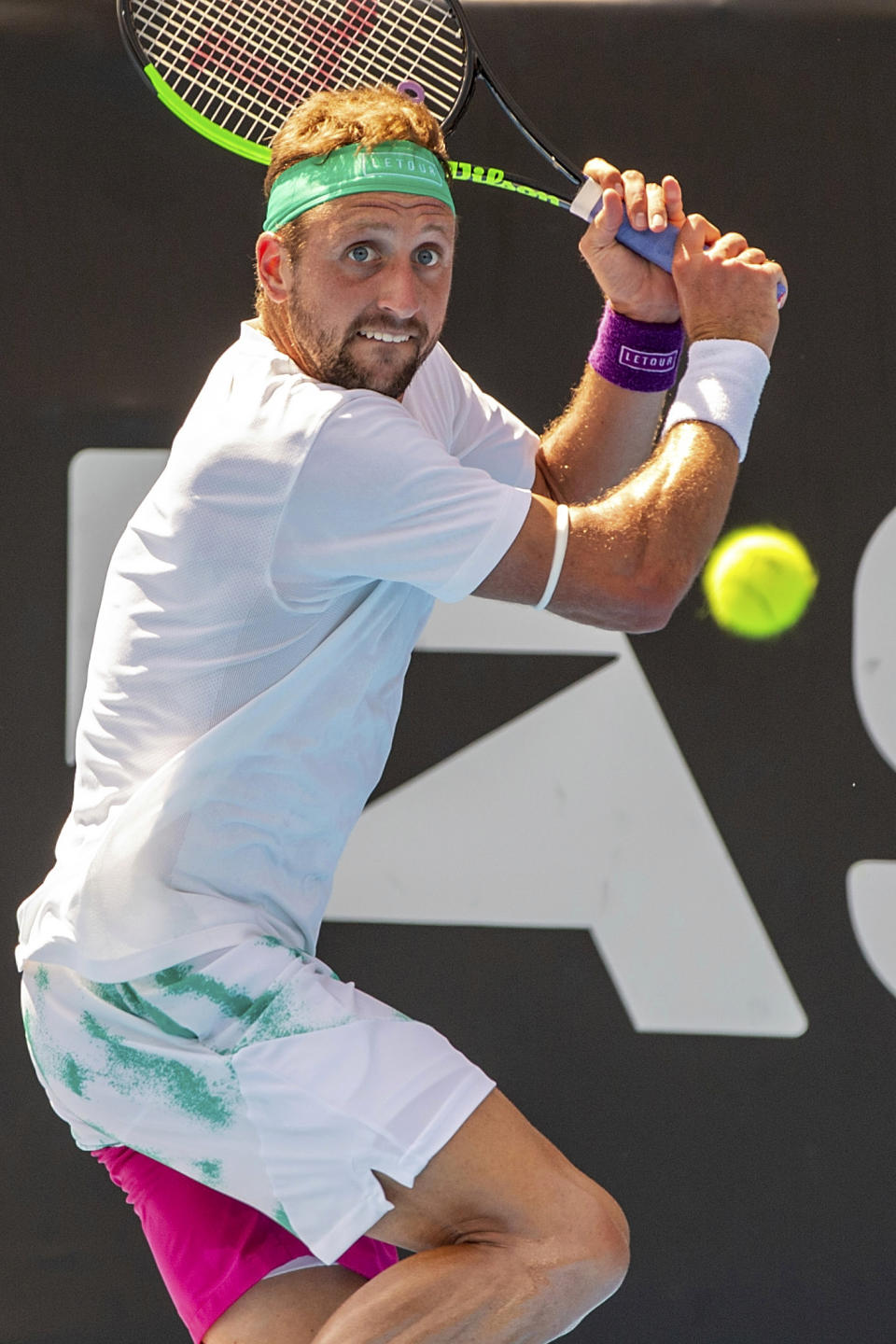 Tennys Sandgren of the U.S. plays a shot against Britain's Cameron Norrie during their singles final match in the ASB Classic at ASB Tennis Arena in Auckland, New Zealand, Saturday, Jan. 12, 2019. (AP Photo/David Rowland)