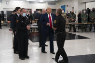 FILE - In this Sept. 1, 2020 file photo, President Donald Trump tours an emergency operations center and meets with law enforcement officers at Mary D. Bradford High School in Kenosha, Wis. Wisconsin Democrats, stung by President Trump's narrow win four years ago, are confident the lessons they learned will ensure he doesn't do it again. But Republicans say civil unrest that followed a police shooting in Kenosha, and Trump's "law and order" message, will help him win over the crucial white suburban voters he needs to capture a second term. (AP Photo/Evan Vucci File)