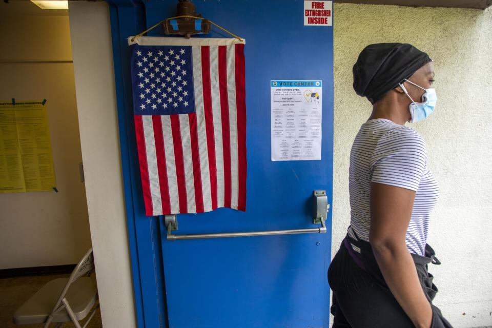 Kalei Taylor-Trim walks past an American flag