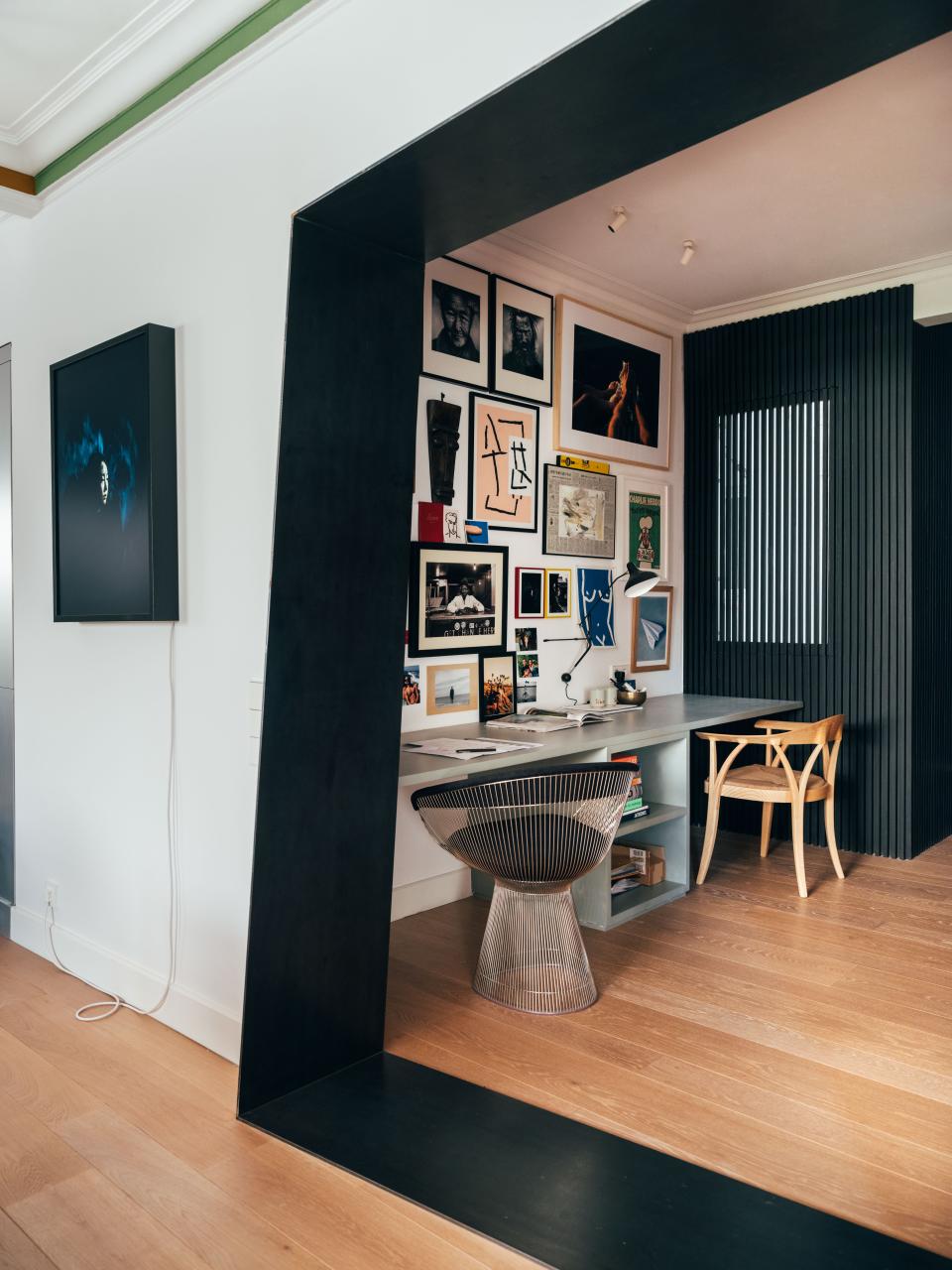 Juan’s company, John Brown Projects, has always worked remotely, so a dedicated office space was important even pre-quarantine. “For my desk, I wanted to be surrounded by my favorite items collected throughout time,” he says. A Platner armchair by Knoll adds a mod touch to the room, and photography by Mahala Nuuk hangs outside the angled doorway.