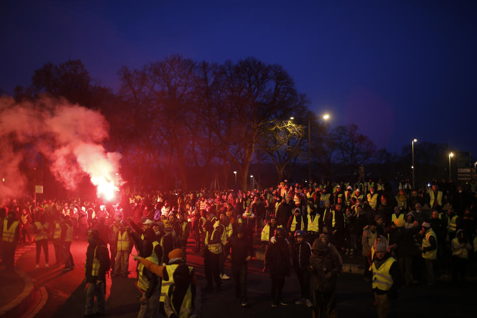 Yellow vest protestors occupy a roundabout in in Bourges, central France, Saturday, Jan. 12, 2019. Paris brought in armored vehicles and the central French city of Bourges shuttered shops to brace for new yellow vest protests. The movement is seeking new arenas and new momentum for its weekly demonstrations. Authorities deployed 80,000 security forces nationwide for a ninth straight weekend of anti-government protests. (AP Photo/Rafael Yaghobzadeh)