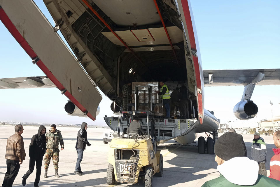 In this photo released by the official Syrian state news agency SANA, workers unload humanitarian aid sent from Saudi Arabia for Syria following a devastating earthquake, at the airport in Aleppo, Syria, Tuesday, Feb. 14, 2023. The first Saudi plane carrying 35 tons of food aid landed in government-held Aleppo airport Tuesday morning, according to Syrian state media. Saudi Arabia, unlike most other Arab countries including the United Arab Emirates, have not rekindled ties with embattled Syrian President Bashar Assad in recent years. (SANA via AP)