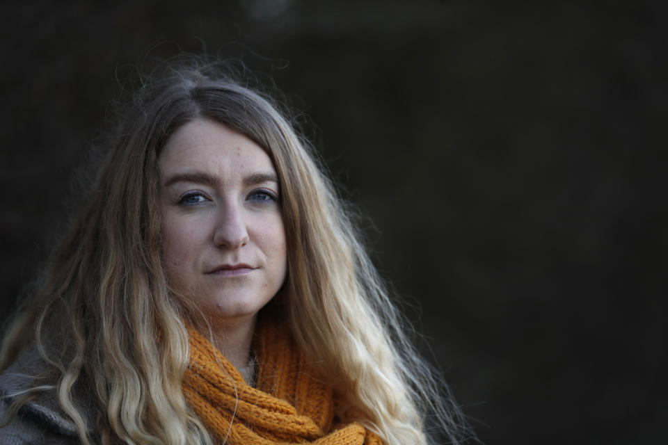 Jo Goodman poses for a portrait in London, Friday, Jan. 22, 2021. Jo's father Stuart died of COVID-19, in April 2020. A couple of months after her father died, Goodman, 32, co-founded the COVID-19 Bereaved Families for Justice group to pressure the government to back a public inquiry into how the pandemic was handled last spring. (AP Photo/Alastair Grant)