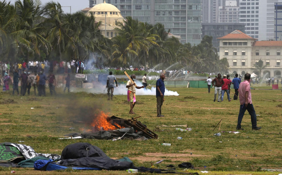 Sri Lanka's pro government supporters vandalise the camps of anti government protestors outside the president's office in Colombo, Sri Lanka, Monday, May 9, 2022. Government supporters on Monday attacked protesters who have been camped outside the office of Sri Lanka's prime minster, as trade unions began a "Week of Protests" demanding the government change and its president to step down over the country's worst economic crisis in memory. (AP Photo/Eranga Jayawardena)