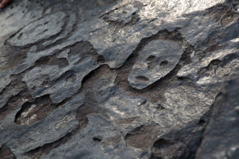 Ancient carvings on Amazon river rock exposed by falling water level during drought in Manaus