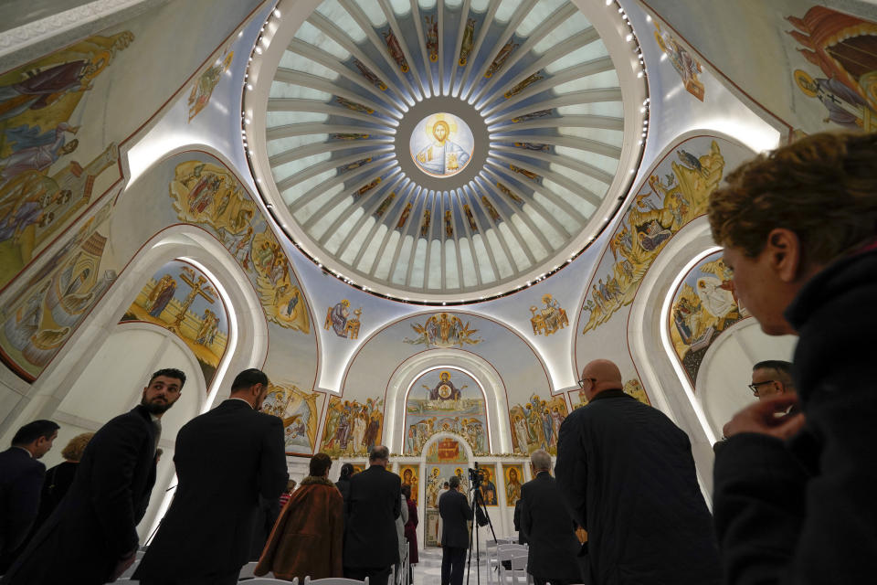 People attend a service at St. Nicholas Greek Orthodox Church in New York, Tuesday, Dec. 6, 2022. After a rebuilding process that lasted more than two decades, the Greek Orthodox church that was destroyed in the Sept. 11 attacks has reopened at the World Trade Center site. The St. Nicholas Greek Orthodox Church and National Shrine, designed by architect Santiago Calatrava, now overlooks the Trade Center memorial pools from an elevated park. (AP Photo/Seth Wenig)